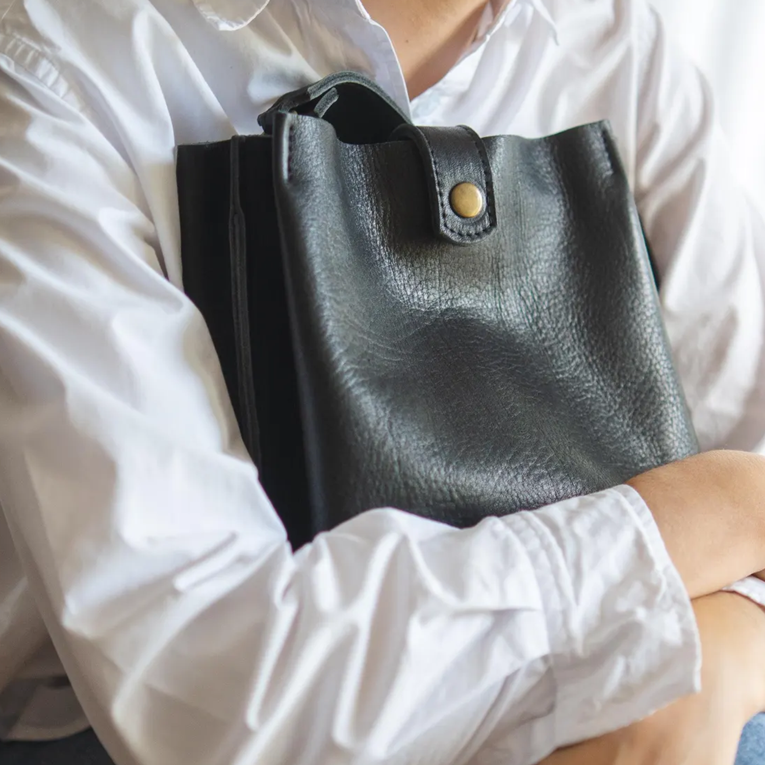 Deep Black Natural Grain Vertical Compact Bucket Carry With Fixed Short Top Loop, Buckle Adjustable Shoulder Strap And Internal Full-Length Zip Divider Compartment
