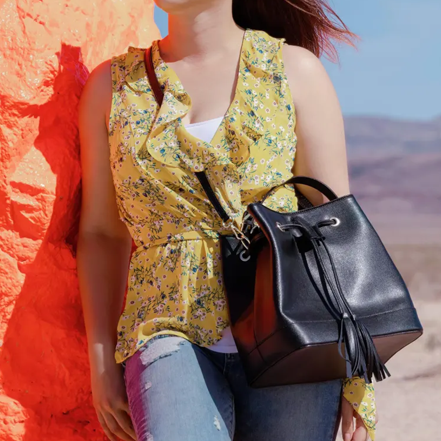 Glossy Jet Black Fine Grain Structured Bucket Handbag With Tassel Drawstring Cinch Rim, Integrated Short Top Loop And Perforated Adjustable Shoulder Strap Hardware