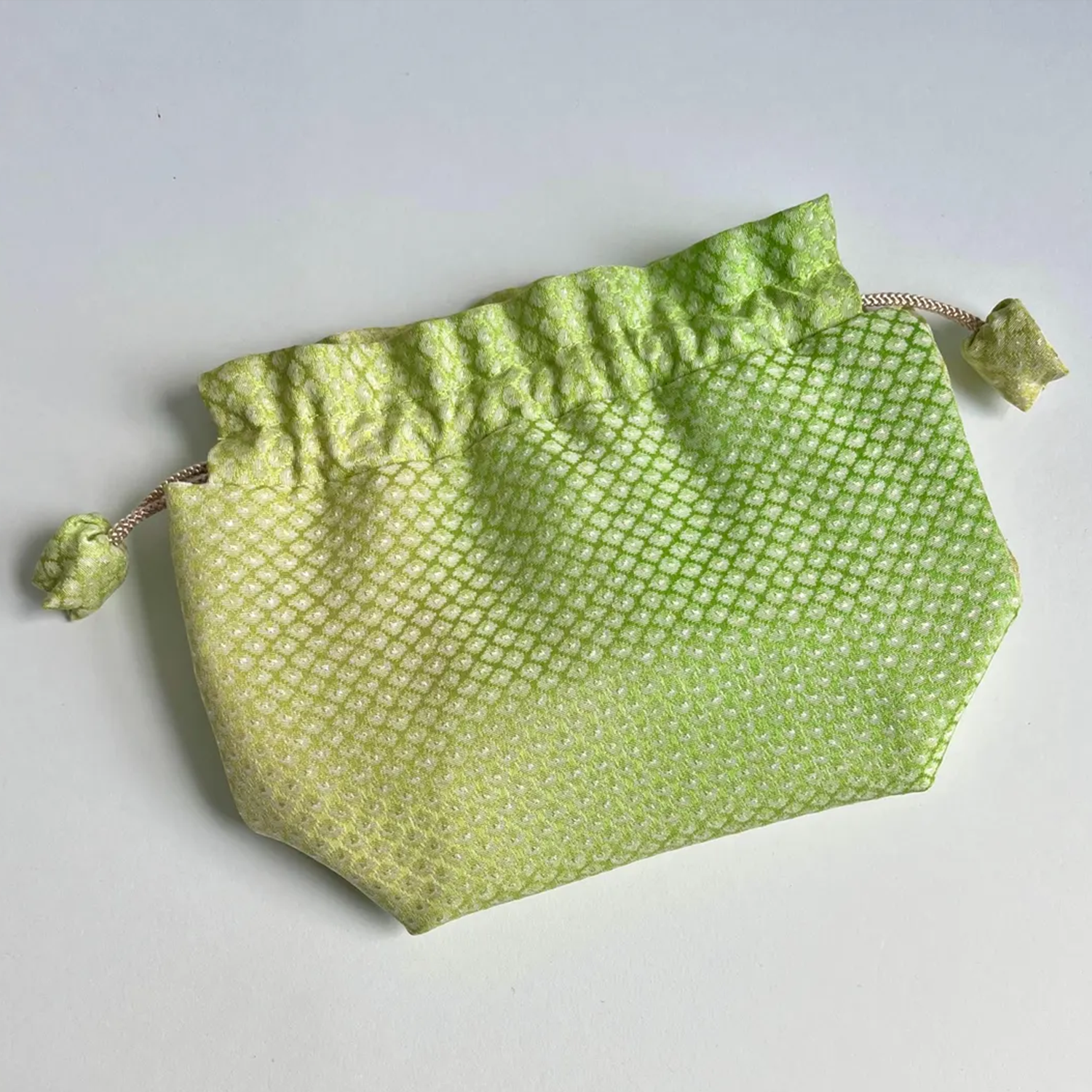 Gradient Light Green Textured Woven Drawstring Bucket Pouch With Ruffled Gathered Top, Fabric Wrapped Cord Toggles And Flat Collapsible Soft Silhouette