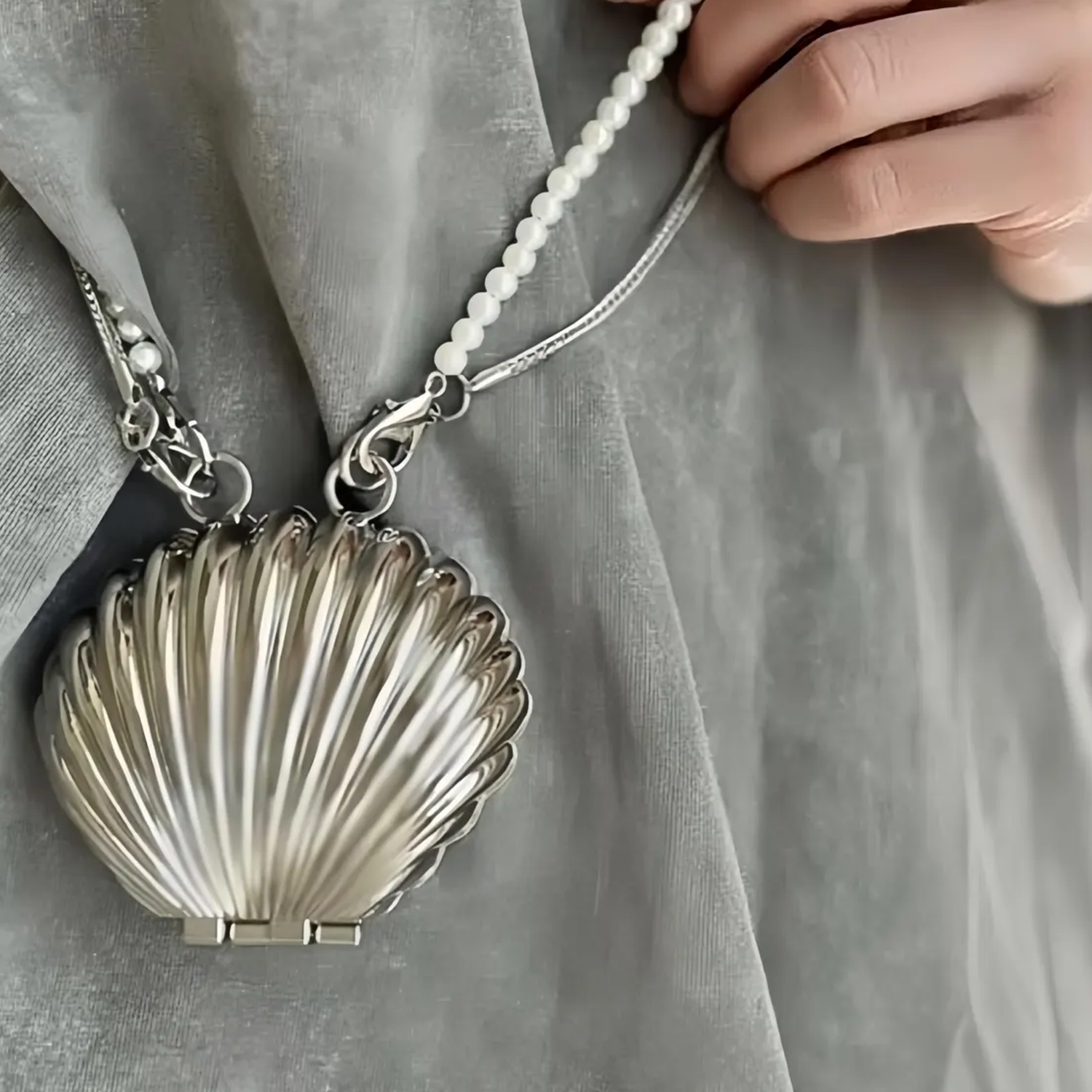 Dual Tone Polished Ribbed Metal Seashell Mini Clutch With Pearl Bead Strand, Slim Metallic Snake Chain And Hidden Magnetic Hinge Closure Wristlet