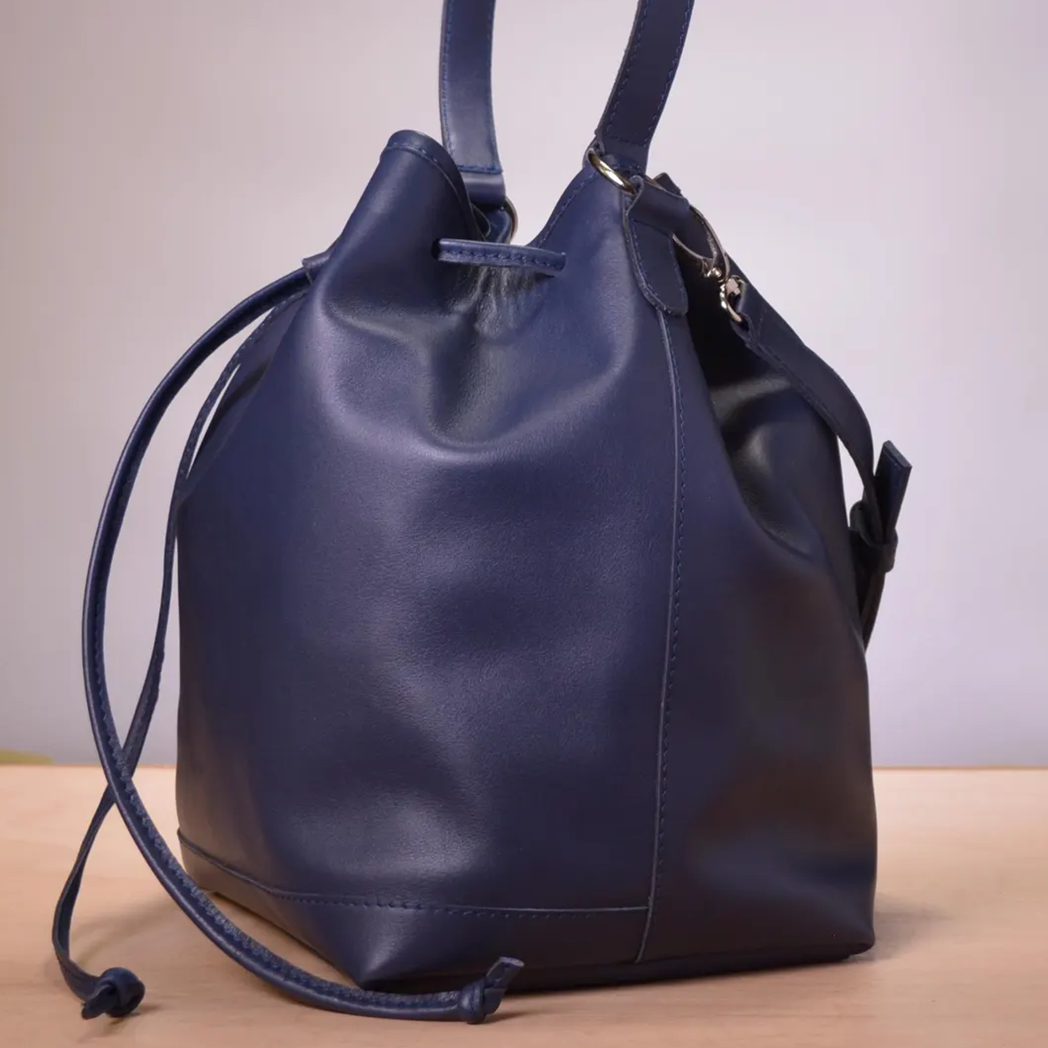 Rich Navy Smooth Matte Leather Slouchy Bucket Carry With Drawstring Cinch Rim, Fixed Short Top Loop And Buckle Adjustable Shoulder Strap Hardware