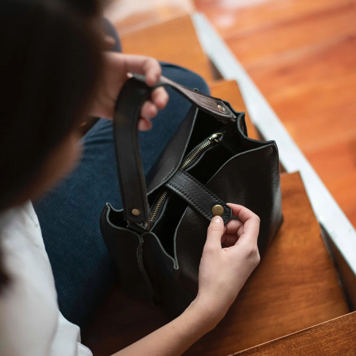 Deep Black Natural Grain Vertical Compact Bucket Carry With Fixed Short Top Loop, Buckle Adjustable Shoulder Strap And Internal Full-Length Zip Divider Compartment