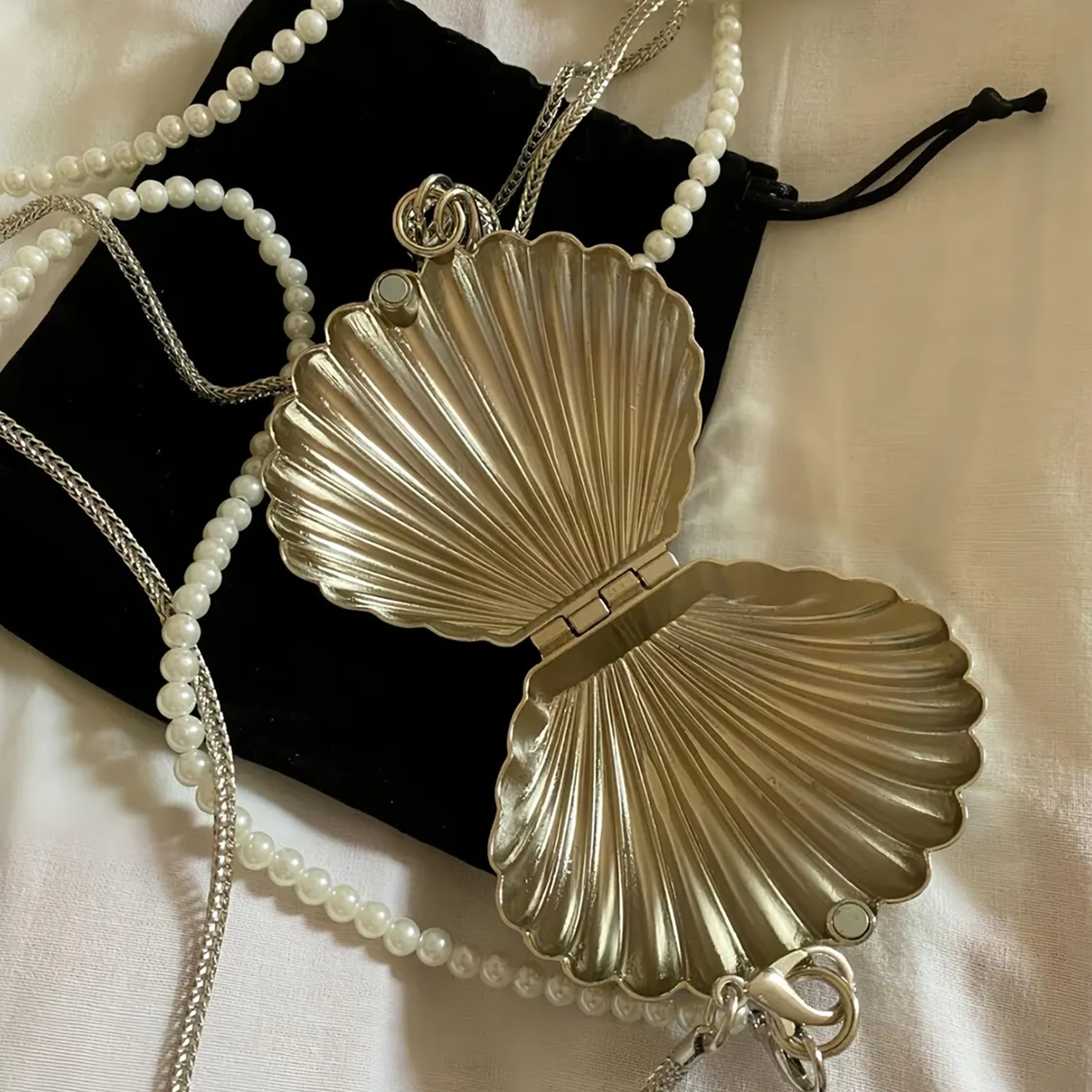 Dual Tone Polished Ribbed Metal Seashell Mini Clutch With Pearl Bead Strand, Slim Metallic Snake Chain And Hidden Magnetic Hinge Closure Wristlet