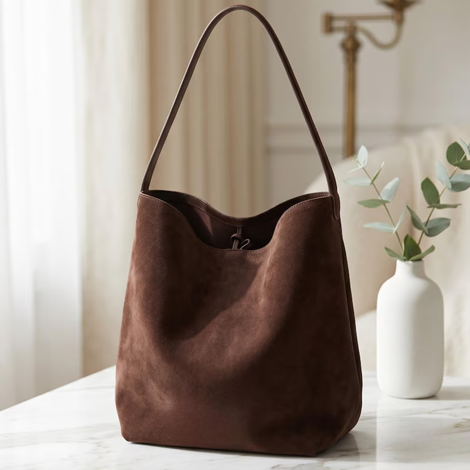 Dark Brown Matte Suede Slouchy Vertical Bucket Shoulder Tote With Single Slim Integrated Shoulder Strap And Interior Drawstring Rim Tab Detail