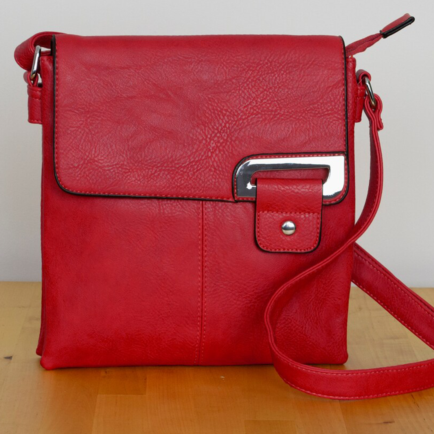 Vibrant Scarlet Pebbled Grain Upright Square Flap Shoulder Carry With Curved Metallic Flap Accent Plate, Rear Full-Width Zip Pocket And Divided Segmented Main Interior